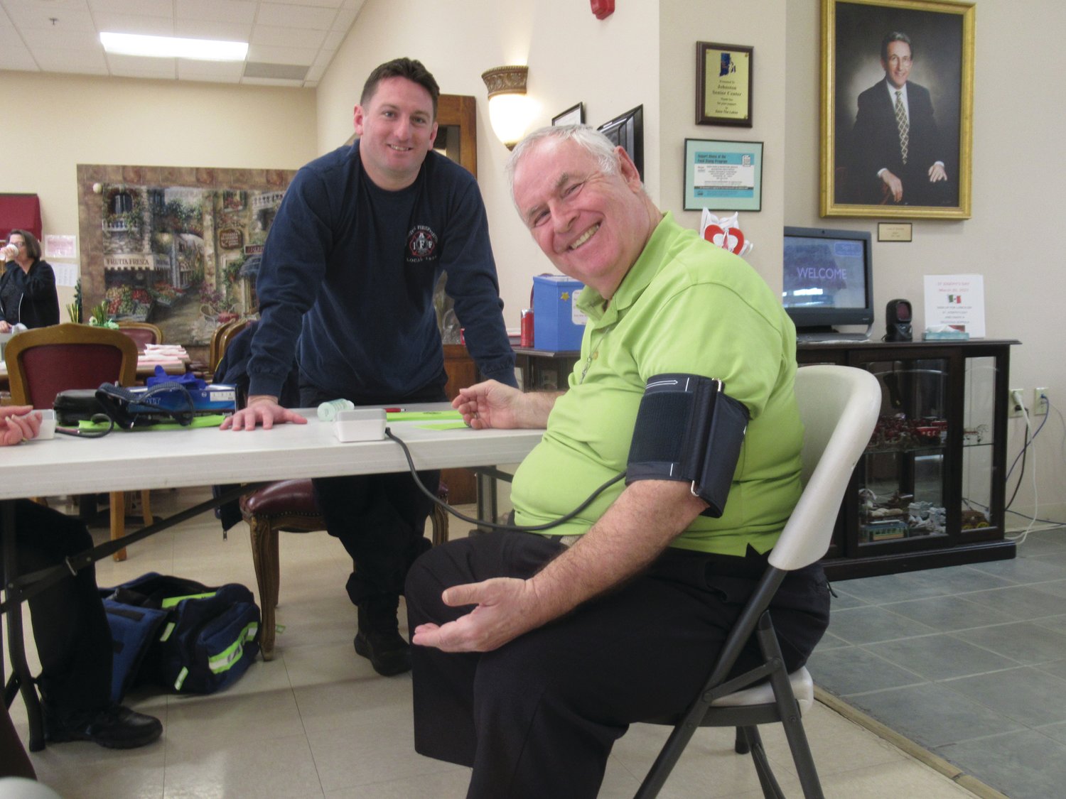 DELIGHTFUL DUTY: JFD Rescue Lt. Joe Pingitore enjoys a lighter moment with Bob Balmforth during last Thursday’s inaugural Blood Pressure Screening Program.
